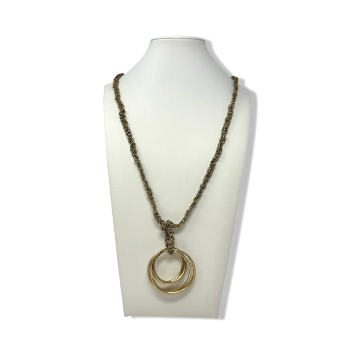 Necklace with a double ring pendant on a mannequin bust against a white background