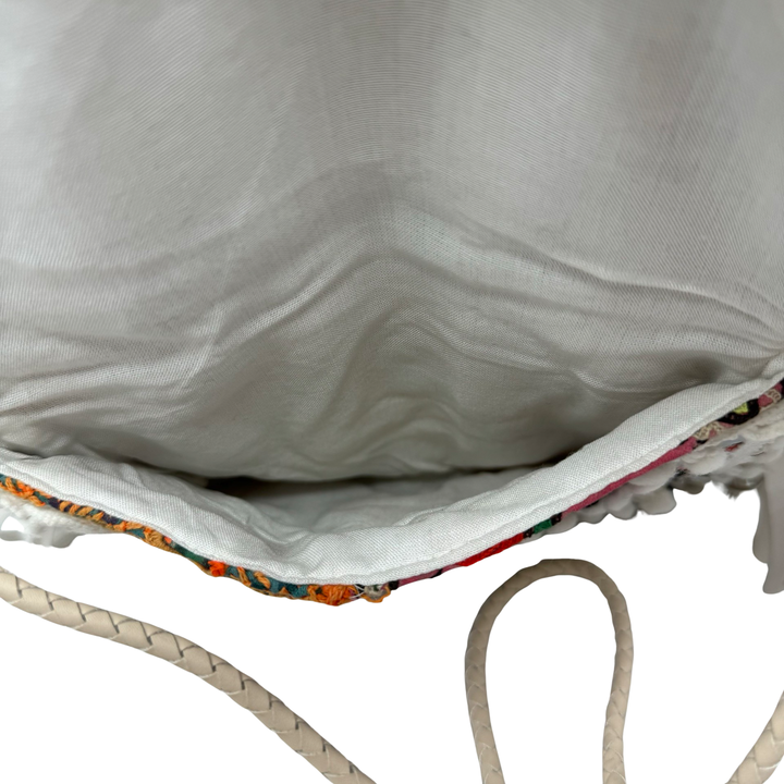 Shashi Small Metal Disc and Pom Pom Crossbody Bag