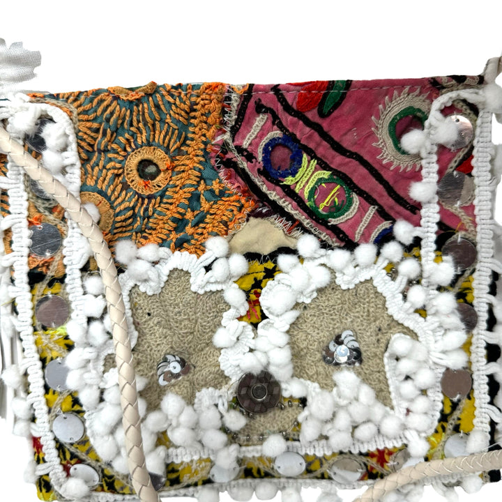 Shashi Small Metal Disc and Pom Pom Crossbody Bag