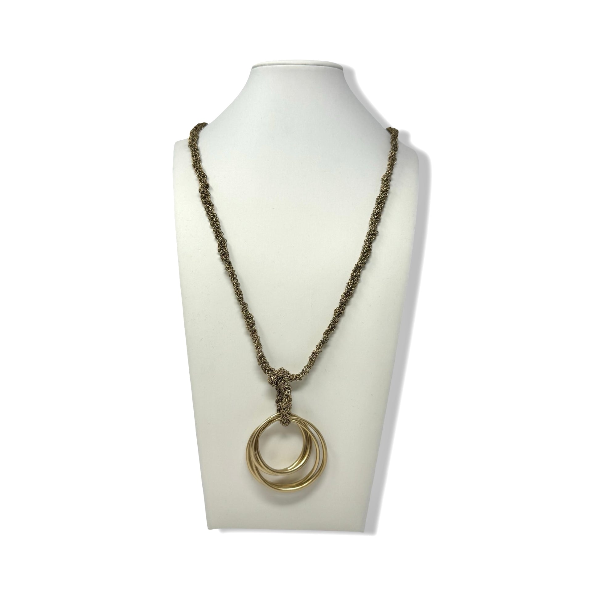 Necklace with a double ring pendant on a mannequin bust against a white background