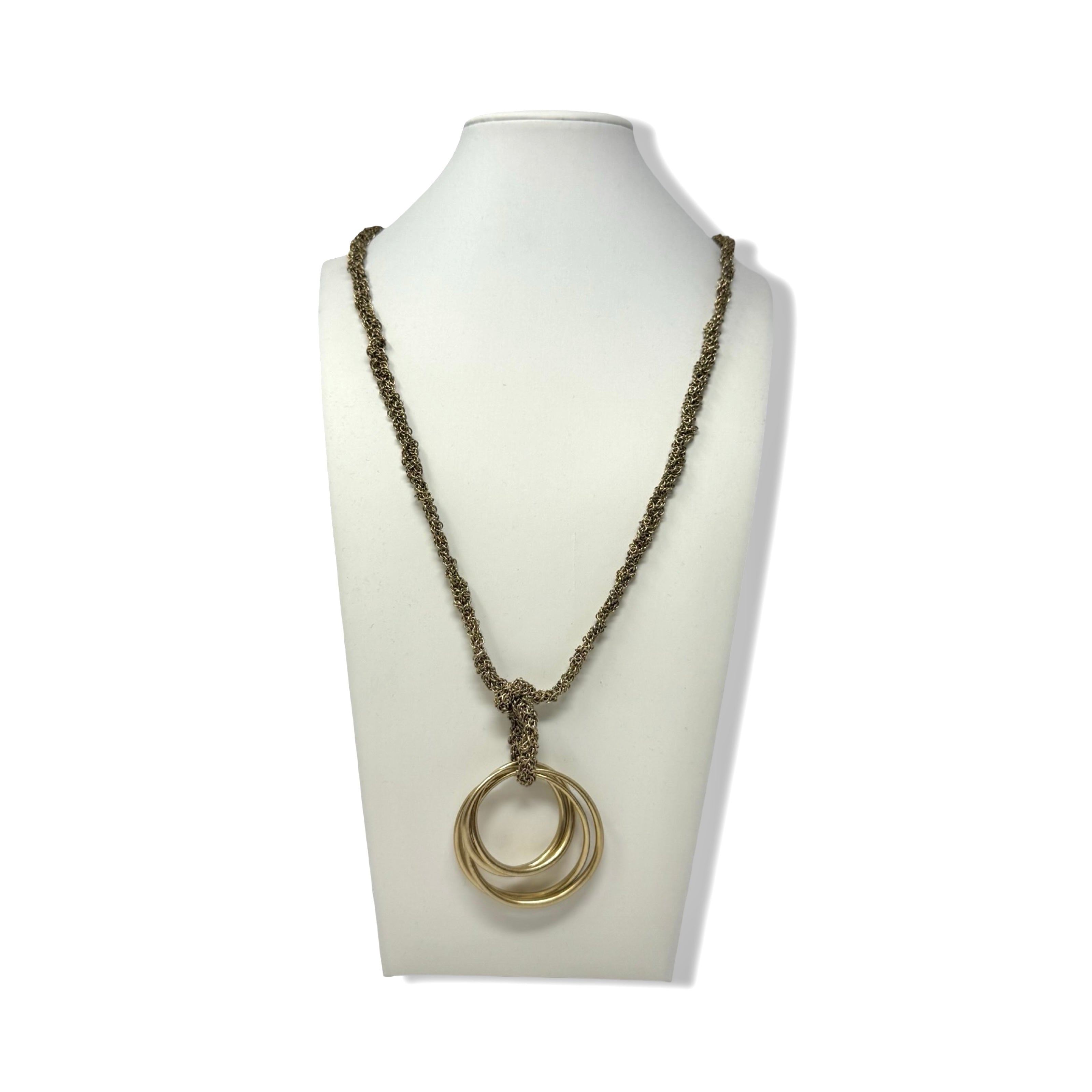 Necklace with a double ring pendant on a mannequin bust against a white background